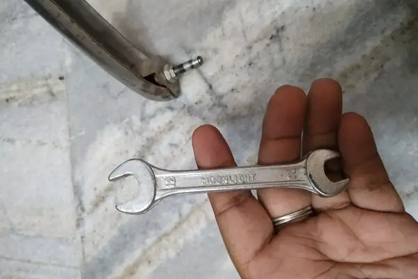 use a spanner to remove old screw